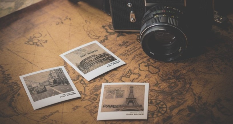 Camera and postcards on map