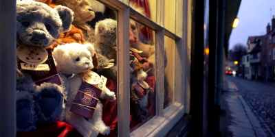 assorted color bear plush toys near glass window