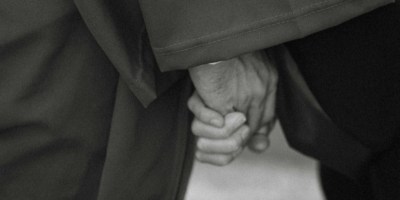 Elderly couple holding hands