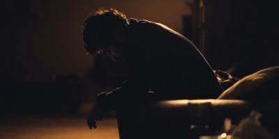 Depressed man sitting in black chair. https://unsplash.com/photos/man-in-black-shirt-sitting-on-chair-ulPAVuxITEw