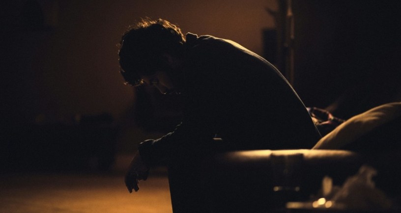 Depressed man sitting in black chair. https://unsplash.com/photos/man-in-black-shirt-sitting-on-chair-ulPAVuxITEw