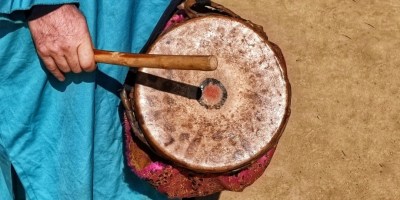 Person banging small drum with stick. Illustration for "Bang the Drum" by Andy Bibble