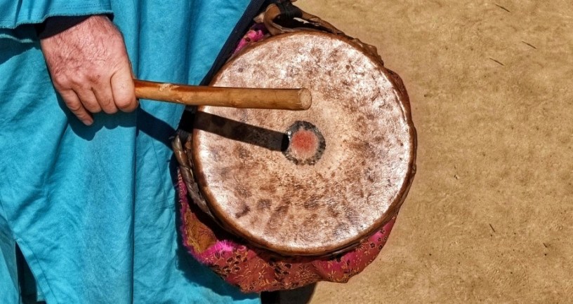 Person banging small drum with stick. Illustration for "Bang the Drum" by Andy Bibble
